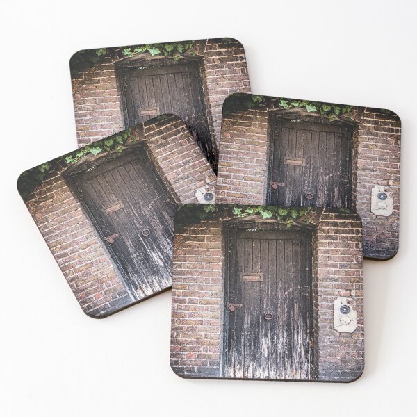 Item preview, Photo of a weathered door covered in green ivy to a secret garden in London designed and sold by Diana van Neck.
