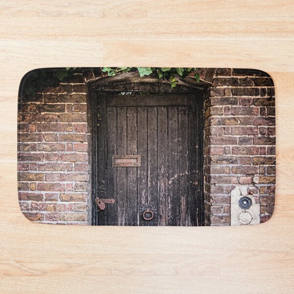 Item preview, Photo of a weathered door covered in green ivy to a secret garden in London designed and sold by Diana van Neck.