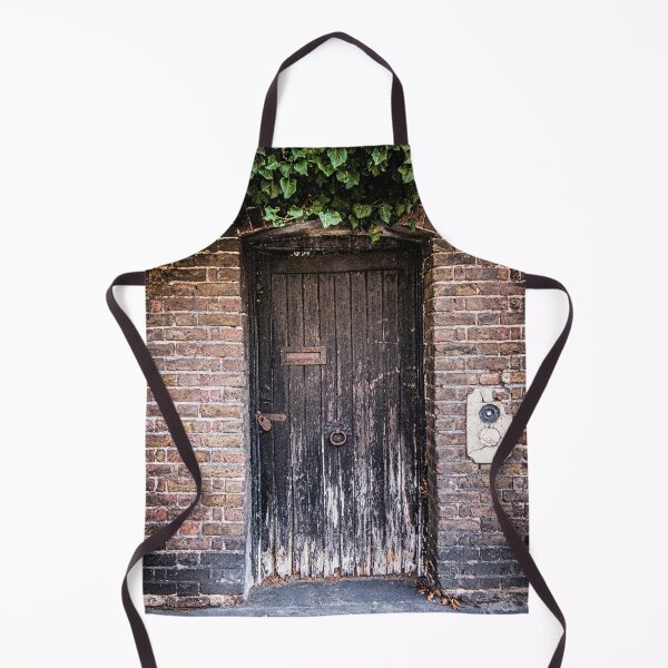Item preview, Photo of a weathered door covered in green ivy to a secret garden in London designed and sold by Diana van Neck.