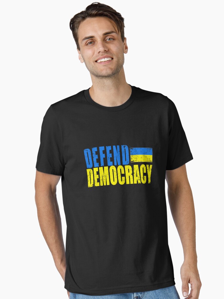 Thumbnail 1 of 7, Essential T-Shirt, DEFEND DEMOCRACY with UKRAINIAN FLAG DISTRESSED designed and sold by LoveAndDefiance.