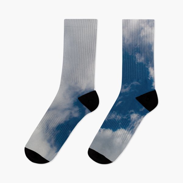 Item preview, A hole through thick fluffy white clouds showing the deep blue sky behind designed and sold by James-Cole.