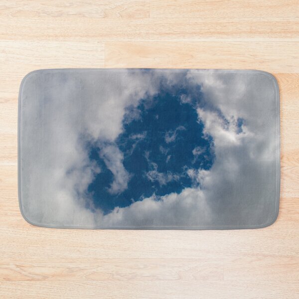 Item preview, A hole through thick fluffy white clouds showing the deep blue sky behind designed and sold by James-Cole.