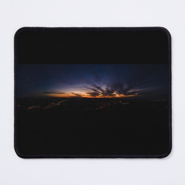 Item preview, Dark wispy clouds in a deep blue sky in the afterglow of an golden sunset above the street lights aerial panoramic designed and sold by James-Cole.