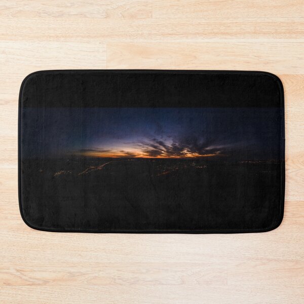 Item preview, Dark wispy clouds in a deep blue sky in the afterglow of an golden sunset above the street lights aerial panoramic designed and sold by James-Cole.
