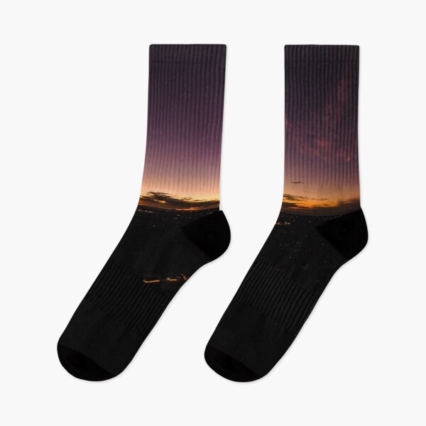 Item preview, Dark horizon clouds in a deep purple sky in the afterglow of an golden sunset above the street lights aerial panoramic designed and sold by James-Cole.