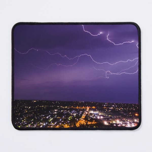 Item preview, Lightning bolt discharging in the stormy clouds above the street lights aerial nighttime shot designed and sold by James-Cole.