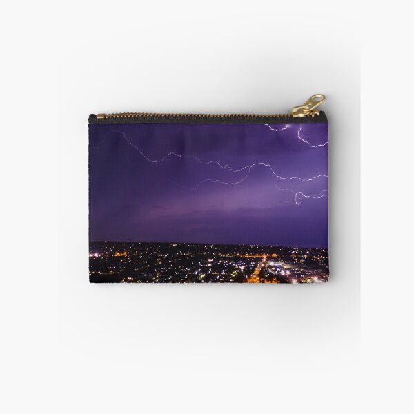 Item preview, Lightning bolt discharging in the stormy clouds above the street lights aerial nighttime shot designed and sold by James-Cole.