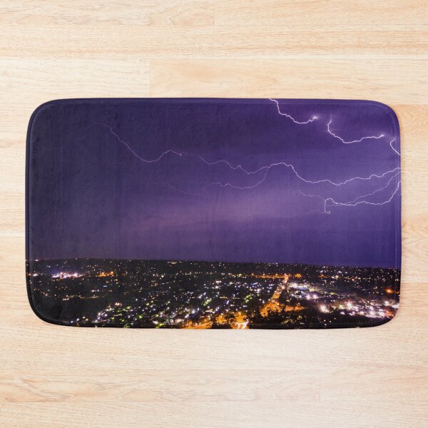 Item preview, Lightning bolt discharging in the stormy clouds above the street lights aerial nighttime shot designed and sold by James-Cole.