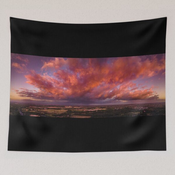 Item preview, Firey storm clouds orange pink and red at sunset with distant rain storm across the landscape aerial panoramic designed and sold by James-Cole.