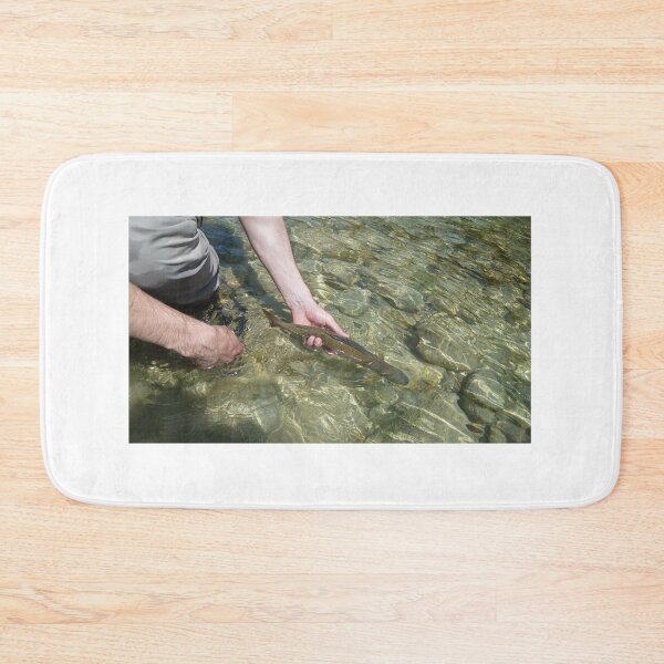 Item preview, Catch and release - A Grayling fish being released back into a river by a fisherman on the Soca River in Slovenia designed and sold by SnapTPhotograph.