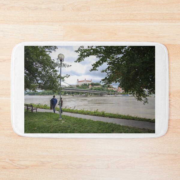 Item preview, People walking along a footpath by the River Danube with the Bratislava Castle designed and sold by SnapTPhotograph.