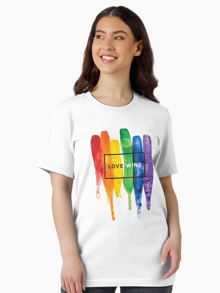 Thumbnail 1 of 7, Essential T-Shirt, Watercolor LGBT Love Wins Rainbow Paint Typographic designed and sold by LGBTIQ.