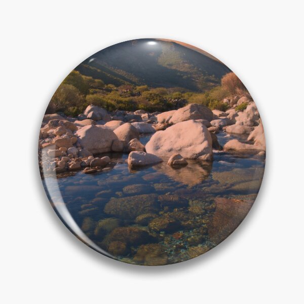 Item preview, Sunrise mountains over rocky river designed and sold by hardscuffle.