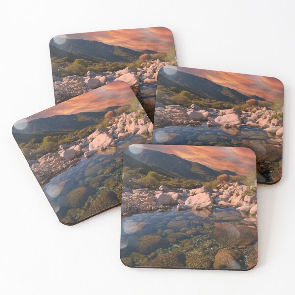Item preview, Sunrise mountains over rocky river designed and sold by hardscuffle.