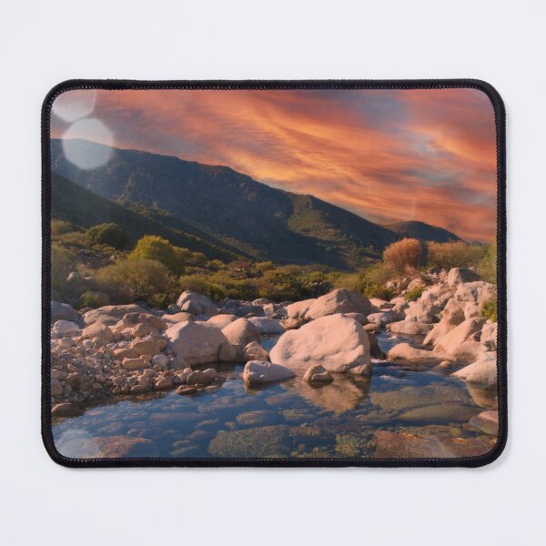 Item preview, Sunrise mountains over rocky river designed and sold by hardscuffle.