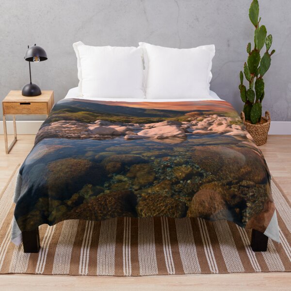Item preview, Sunrise mountains over rocky river designed and sold by hardscuffle.