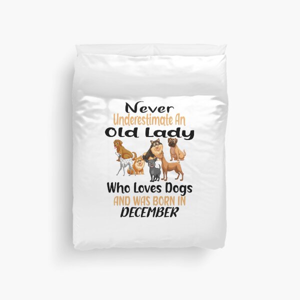 Item preview, Never Underestimate An Old Lady Who Loves Dogs And Was Born In December designed and sold by boyastore.
