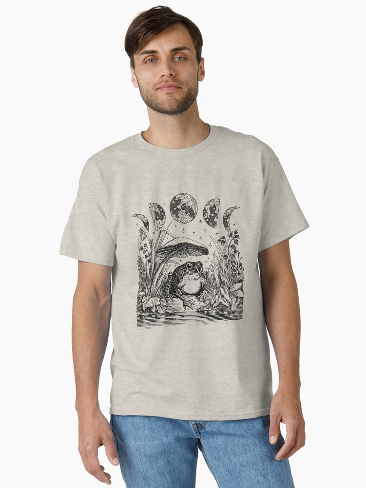 Thumbnail 1 of 7, Classic T-Shirt, Cottagecore Aesthetic Frog, Mushroom Moon Witchcraft: Vintage Dark Academia, Goblincore Froggy, Emo Grunge Nature Fantasy, Fairycore Toad in Toadstool Pond designed and sold by MinistryOfFrogs.
