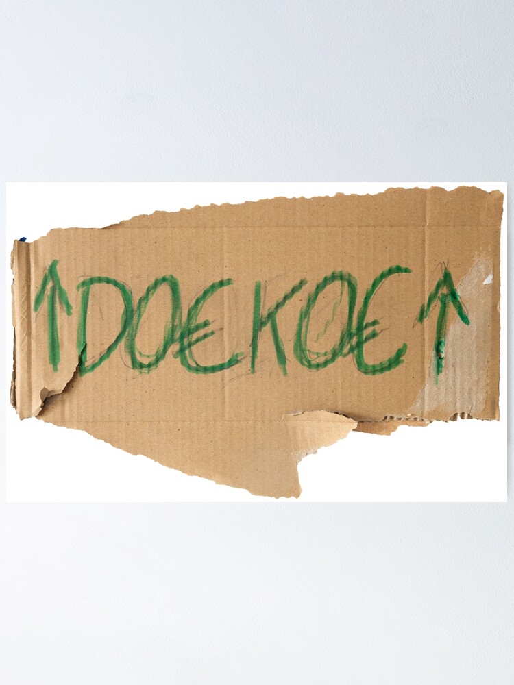 "Cardboard protest board with the word doekoe and arrows pointing