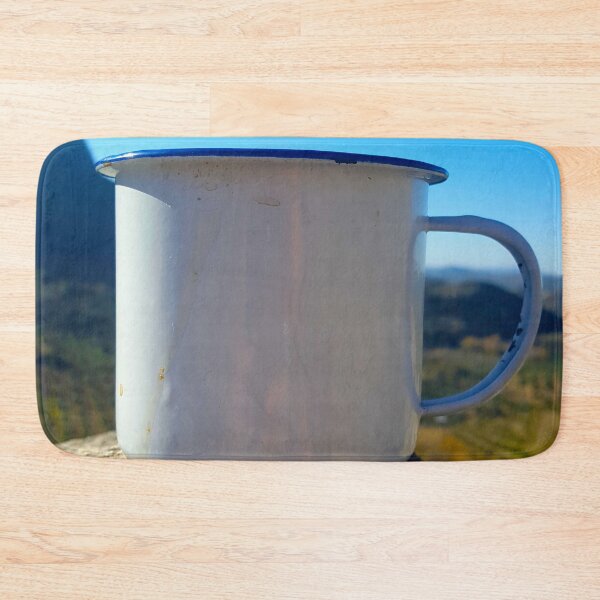 Item preview, A white enamel metal camping mug sat on a rock with mountain and blue sky. designed and sold by janesg.