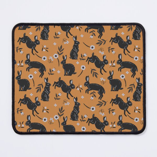 Item preview, pattern with black rabbits and flowers on an orange background designed and sold by burbura.