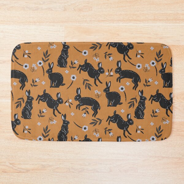 Item preview, pattern with black rabbits and flowers on an orange background designed and sold by burbura.