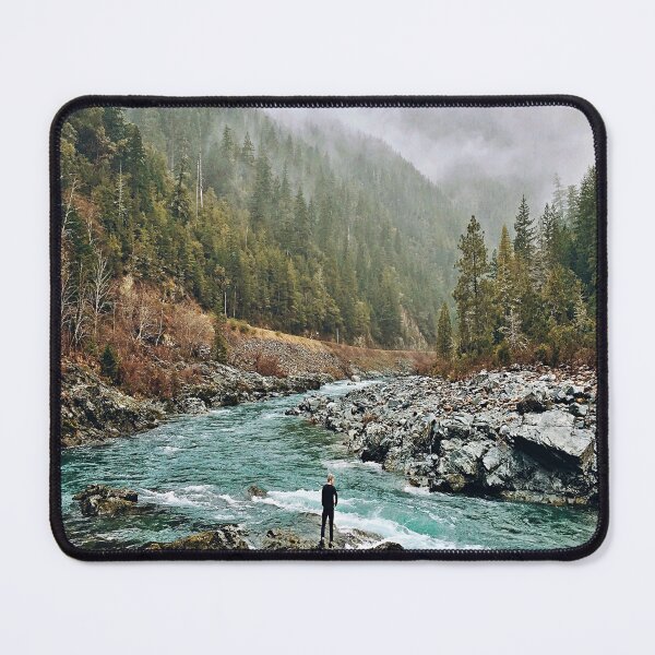 Item preview, Forest Photography - A man standing on jagged rocks in a fast-flowing river in the wilderness designed and sold by Tjokko-chan.