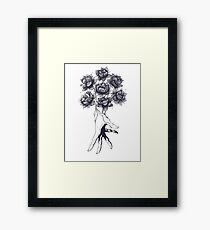 Hand with lotuses on black Framed Print