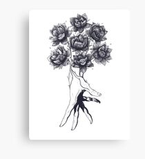 Hand with lotuses on black Canvas Print