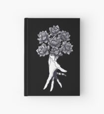 Hand with lotuses on black Notizbuch