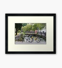 Bicycles by the river Framed Print