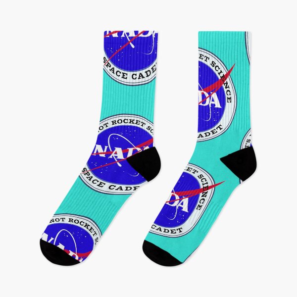 Item preview, NADA - NASA Space Cadet logo on badge with the motto, It's not rocket science. At the center is the spanish word for nothing, NADA. designed and sold by the-other-joe.