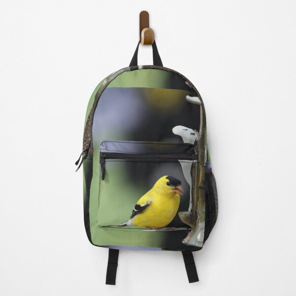 Item preview, Gold Finch on a bird feeder perch with a blurred background in Ontario, Canada designed and sold by AlishaWatson.
