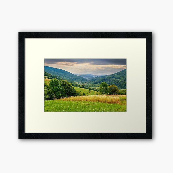village on hillside meadow Framed Art Print