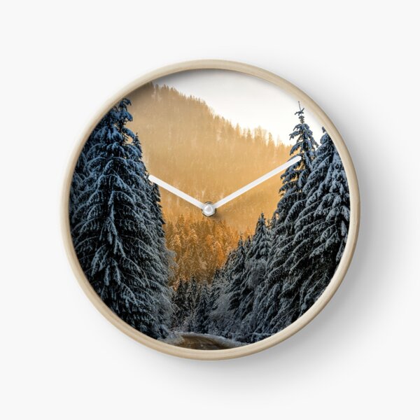 snowy road through spruce forest at sunset Clock