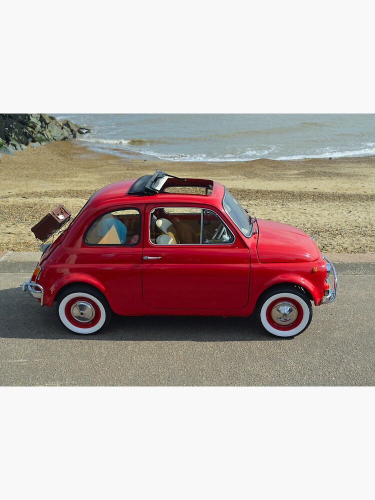 "Classic Red Fiat 500 motor car with picnic basket parked on seafront