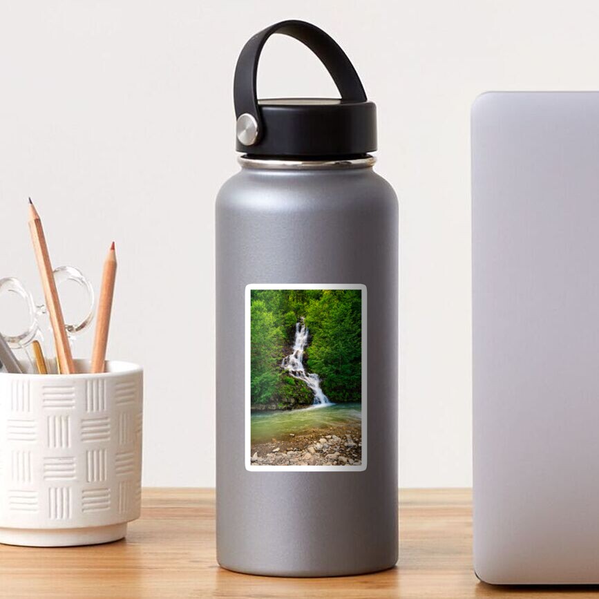 waterfall comes out of a hillside in forest Sticker