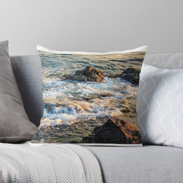 wave rolls onto the rocky coast Throw Pillow
