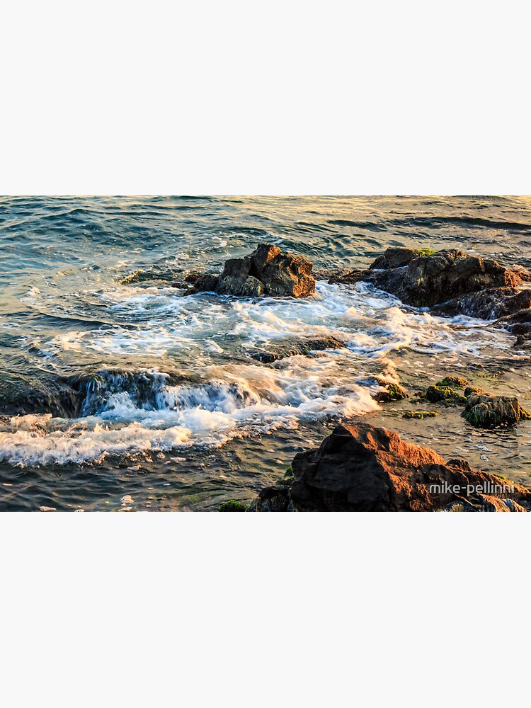 wave rolls onto the rocky coast by mike-pellinni