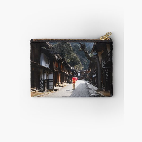 Item preview, Woman under red umbrella walking along the street in rural Japan designed and sold by Raureif.