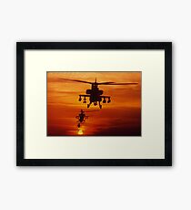 Four AH-64 Apache anti-armor helicopters fly in formation at dusk. Framed Print