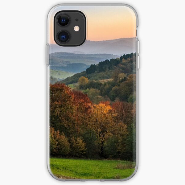 sunset over autumn forest in hazy mountains iPhone Soft Case