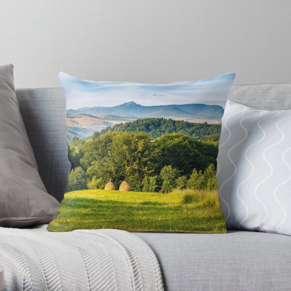 stacks of hay on the hill side Throw Pillow