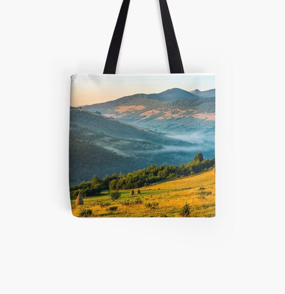 stacks of hay on the hill side All Over Print Tote Bag