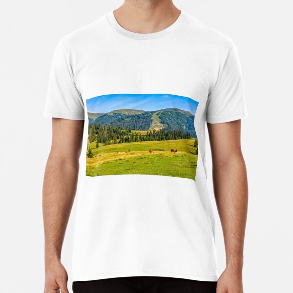 few cows grazing on hillside meadow Premium T-Shirt