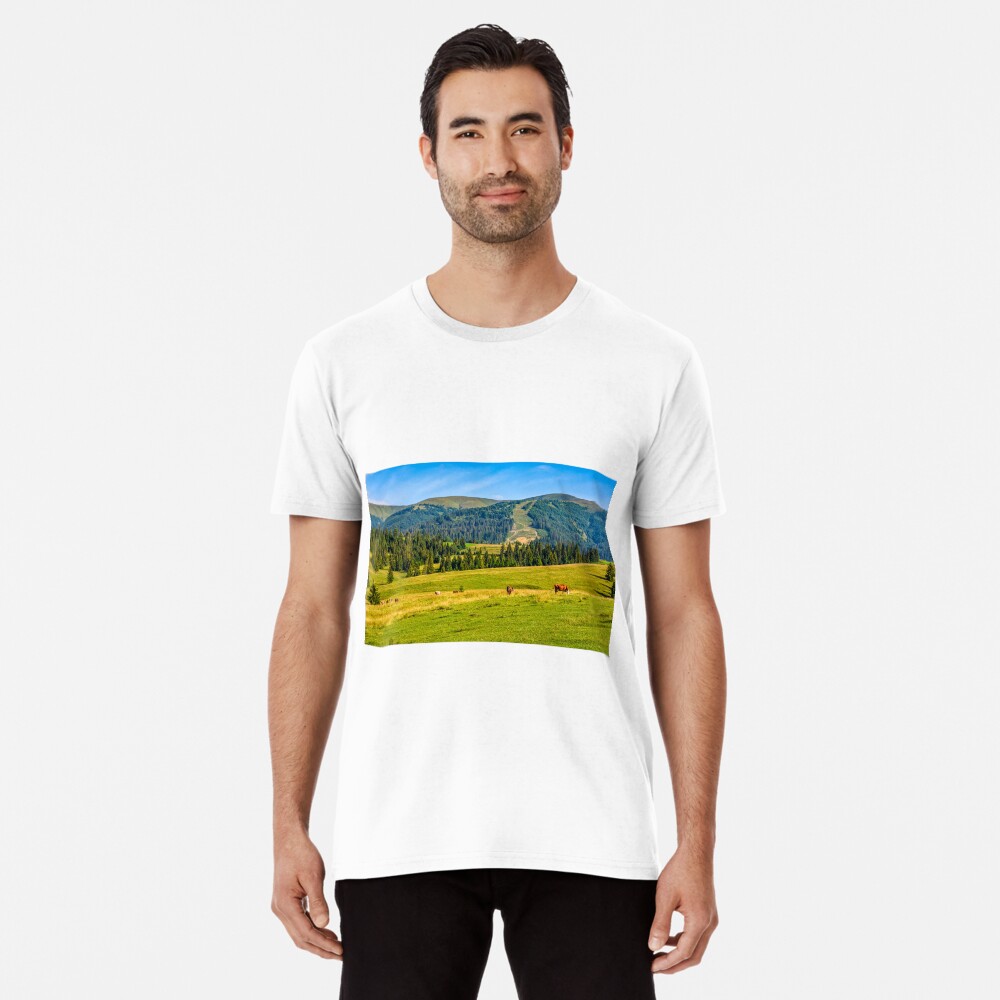 few cows grazing on hillside meadow Premium T-Shirt