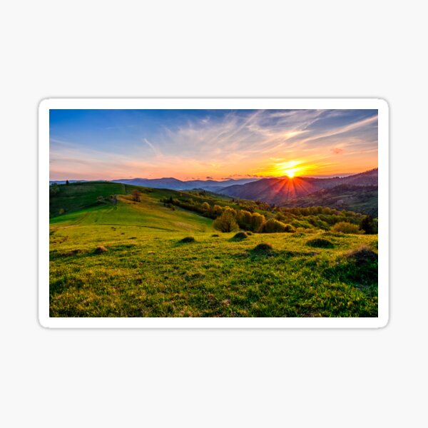 mountain rural area in springtime at cloudy sunset Sticker