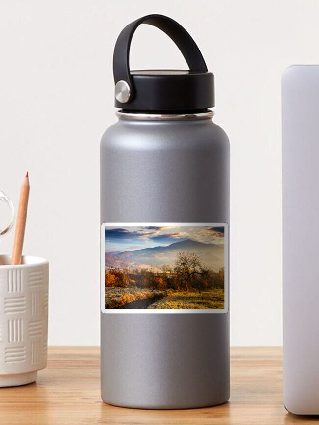 Thumbnail 1 of 3, Sticker, orchard on a hillside at foggy sunrise in mountains designed and sold by mike-pellinni.