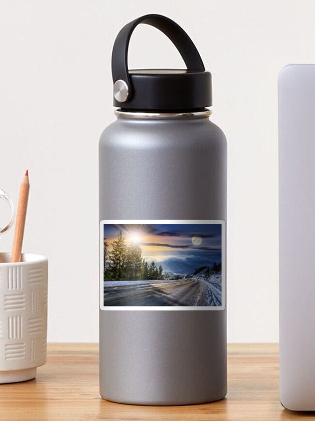 Thumbnail 1 of 3, Sticker, snowy road through spruce forest in mountains designed and sold by mike-pellinni.