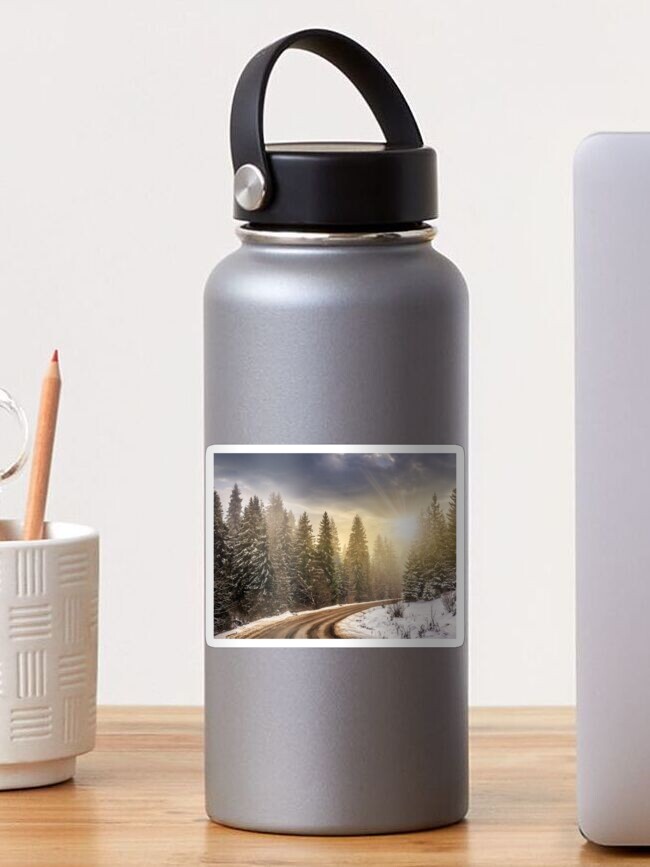 Thumbnail 1 of 3, Sticker, snowy road through spruce forest at sunset designed and sold by mike-pellinni.